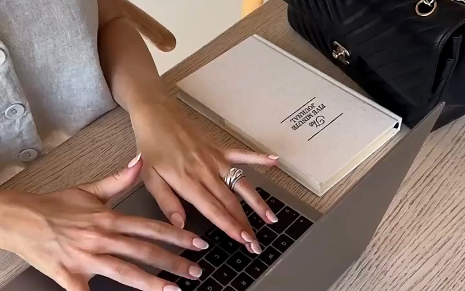 Laptop and notebook on a desk, planning a search strategy